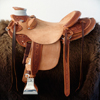 Half Breed Vaquero Wade Saddle by Keith Valley Specs: Wade tree by Rick Reed 15 & 1/2 inch seat, Gullet - 7 & 1/2H X 6 & 1/4W X 4, 93 Degree Bars, Horn - 3 & 5/8ths high X 4 & 1/2 Guatelajara, Cantle - 4&1/2 inches high X 12&1/2 inches wide, Cheyenne Roll - 1 & 3/4 inches, 7/8ths flat plate riggin. Sporting Keith's Vaquero Border with Sheridan Floral tooling within, Stainless Steel Hardware - by Harwood, 4 inch Monel Stirrups, Santa Barbara twisted for easy handling, Vaquero outside stirrup leathers, 100% handmade Mohair Roper Cinch, Hand cut 7 foot latigos for both sides. Made for a special order - **SOLD** but we take orders.